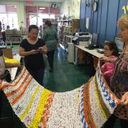 Women holding a finished mat 