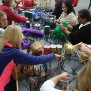 Participants use ribbon to create mesh wreaths.