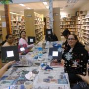 The participants showcase their etched snowflake mirrors.