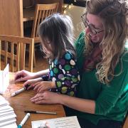 A woman and child working on an activity