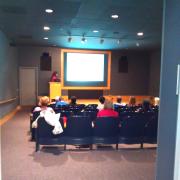 An audience listens to a presentation.