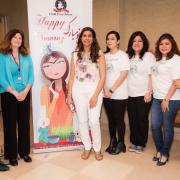 Nowruz Celebration planners and volunteers in front of banner