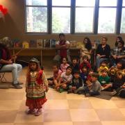 Child in costume in front of an audience