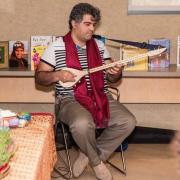 Musician performing in front of displayed books