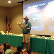 Koch holding up hammerhead fossil