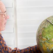 Man looking at globe