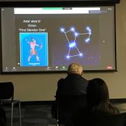  Photo from Navajo Astronomy. Screen shows the slide of presentation with people facing the screen.