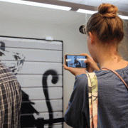 Patron takes photo of art