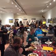 The crowd enjoys Afghan food.