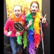 Two children in the phtobooth with props