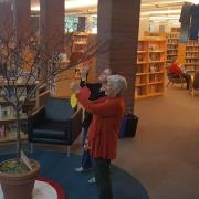 Patrons hang paper leaves on the Poet-tree