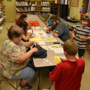 Pokethon participants make origami pikachus