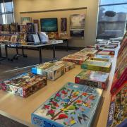 Photograph of tables set up with boxes of puzzles