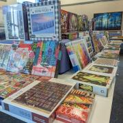 Photograph of tables set up with boxes of puzzles