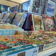 Photograph of tables set up with boxes of puzzles