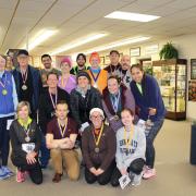 The winners of the Run for Reading 5K pose with their medals.