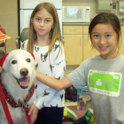 White dog with two children