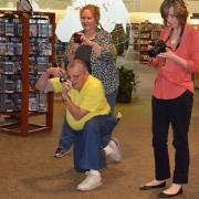 Program participants practice their camera skills in and outside the library.