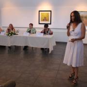 A woman speaks at a panel.