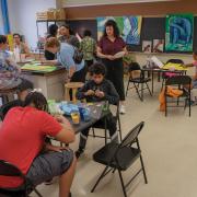 Photograph of participants painting panel art in studio.