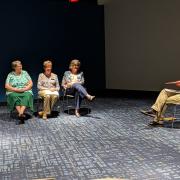 Storyteller talking to seated audience 