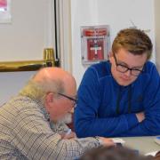 Teen and older man using a tablet