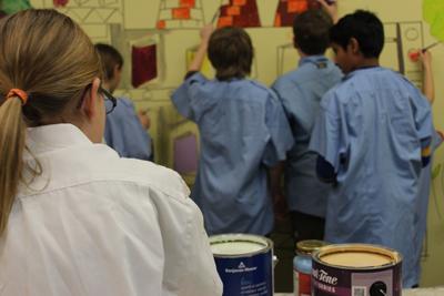 Young artists painting a mural