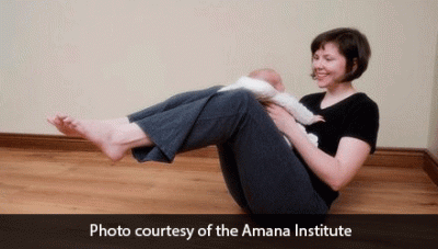 Woman doing boat pose with baby