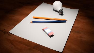 Piece of paper, light bulb, pencil and eraser