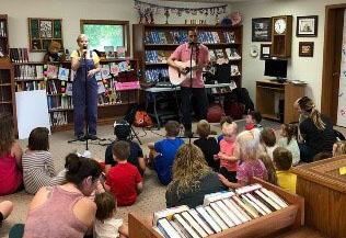 A band performing for a group of children