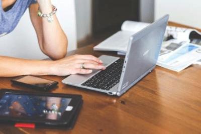 Woman typing on a laptop