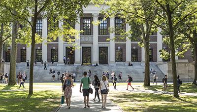 Group of people walking toward a campus building