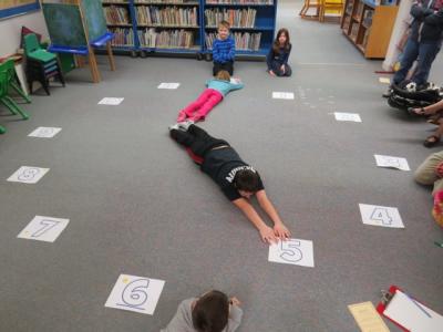 Kids play a time-telling game in the Crazy 8s Math Club.