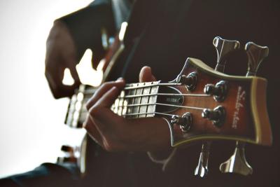 hands playing a guitar