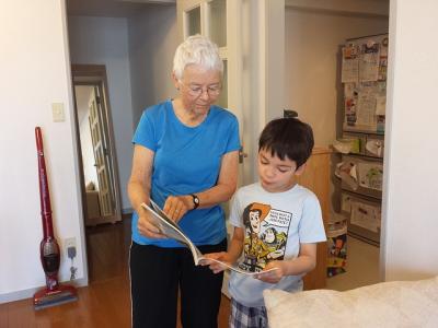 Grandmother reading with grandson