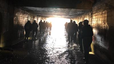 tour group walking through tunnel