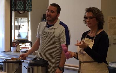 Two people talking in front of an Instant Pot