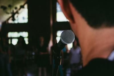 Man standing behind microphone