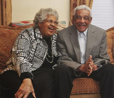 Photo of a smiling couple on couch