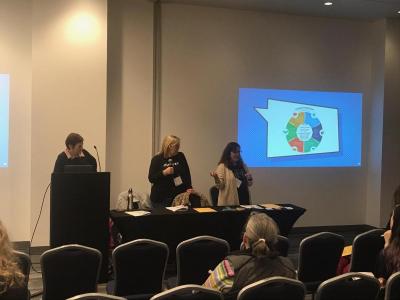 Three women presenting a powerpoint