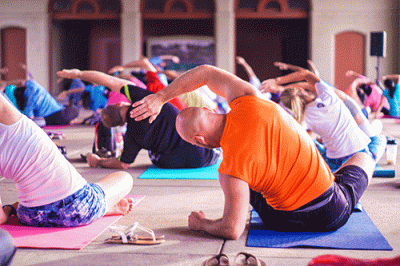 Group doing yoga while seated on ground