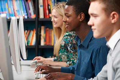 Teens typing and looking at computers