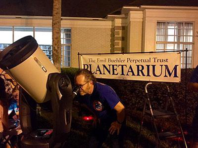 Man looks through telescope