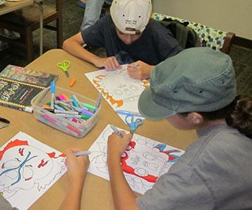 Tweens create art at a Mana-Tweens program.