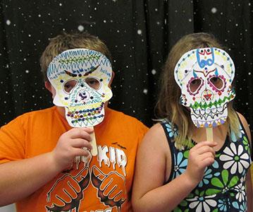 Tweens create masks at a Mana-Tweens program.