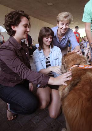 Students take a break with rescue dogs outside of the Linus A. Sims Memorial Library at Southeastern Louisiana University.  (Southeastern Louisiana University Office of Public Information)