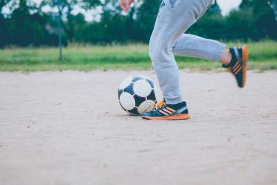 Child kicking soccer ball