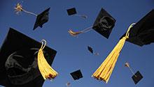 Graduation caps thrown in the air.